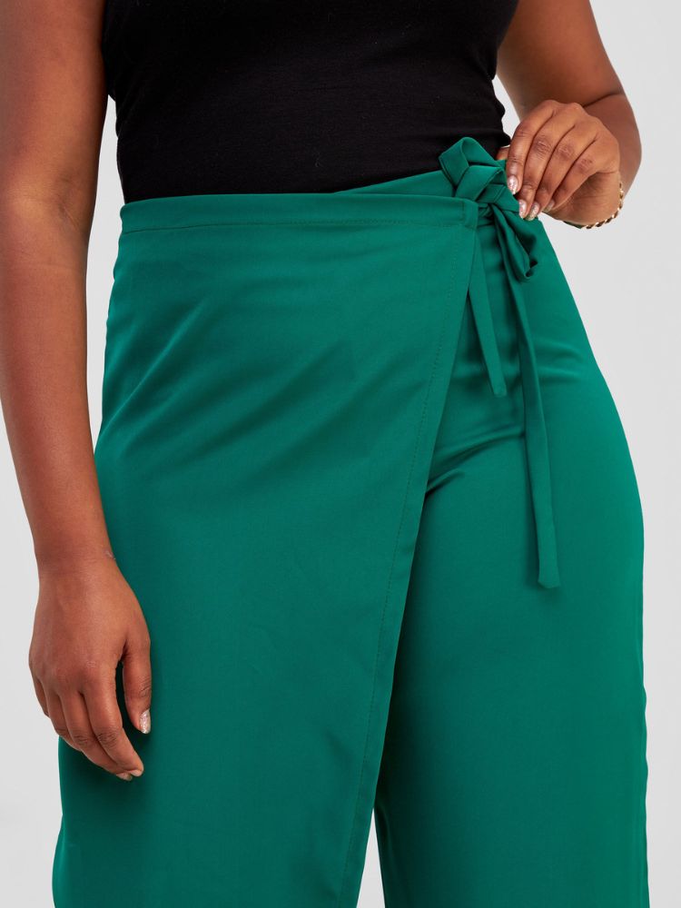 Featuring an attached front overlap that can be stylishly tied at the side, this piece boasts an elasticized back waistband for a perfect fit.