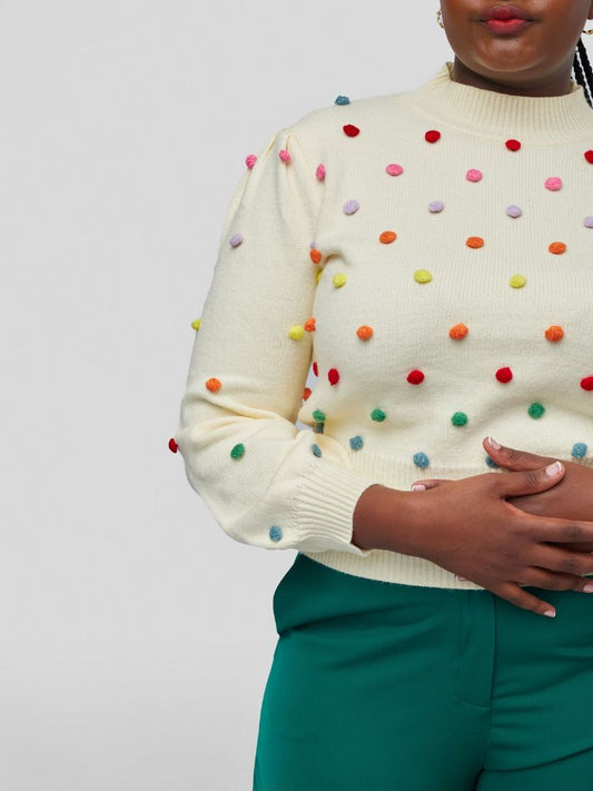 Sweater with a chic mock neckline, long sleeves, and a flattering waist-length fit with colourful knitted balls.