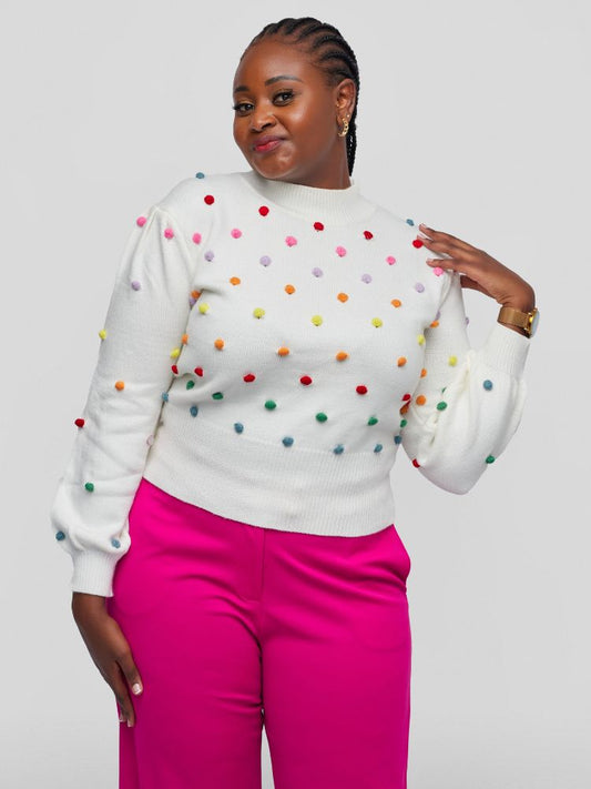 Sweater with a chic mock neckline, long sleeves, and a flattering waist-length fit with colourful knitted balls.